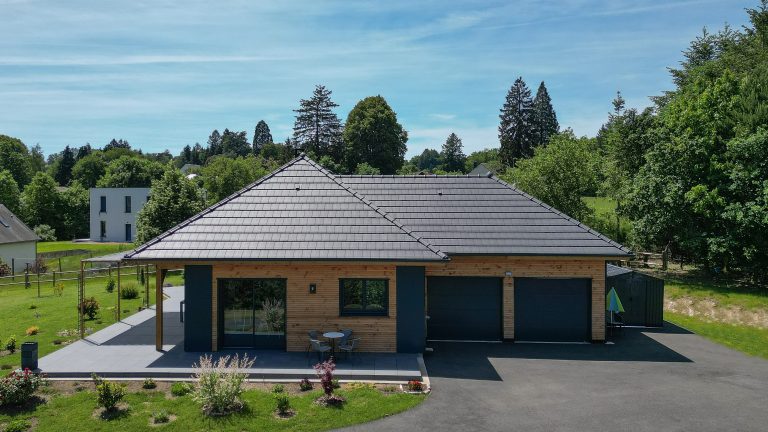 Façade avec double garage d'une maison ossature bois à Égletons
